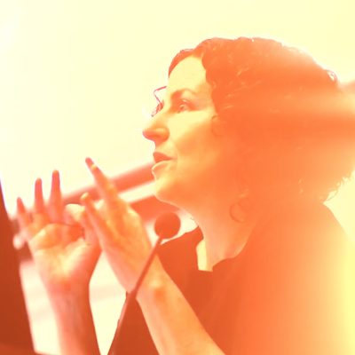 Color photograph of Mara Mills lecturing